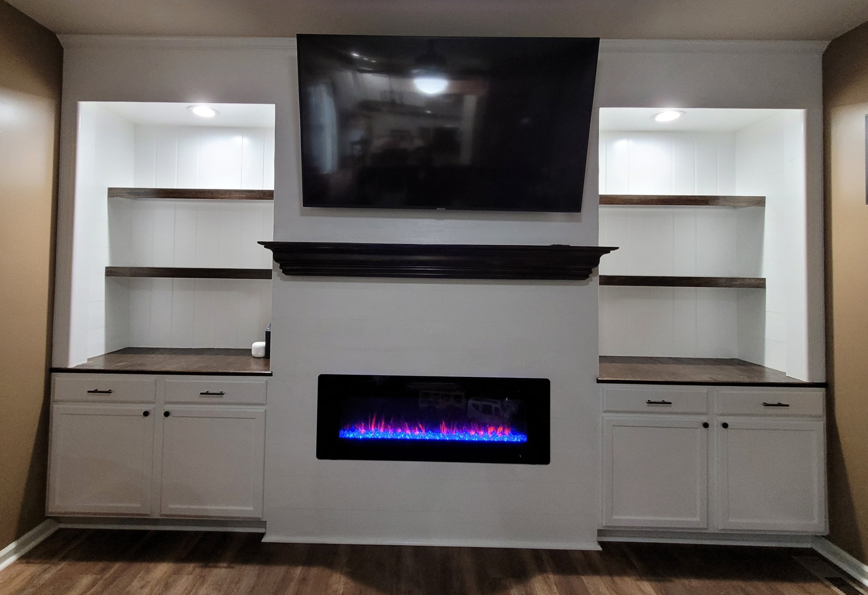 Custom built-in shelves, fireplace, and storage